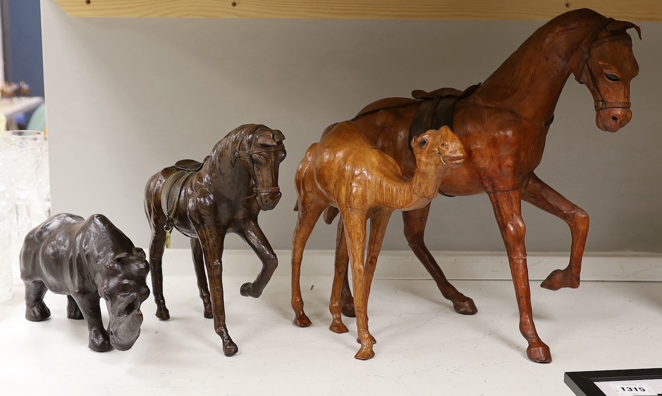 Two leather worked models of horses, a rhinoceros and a camel, tallest 42cm